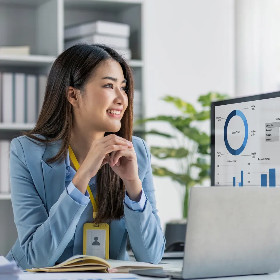 Fotografía de un graduado de un diplomado en business analytics visualizando información en una computadora con un gran monitor.   